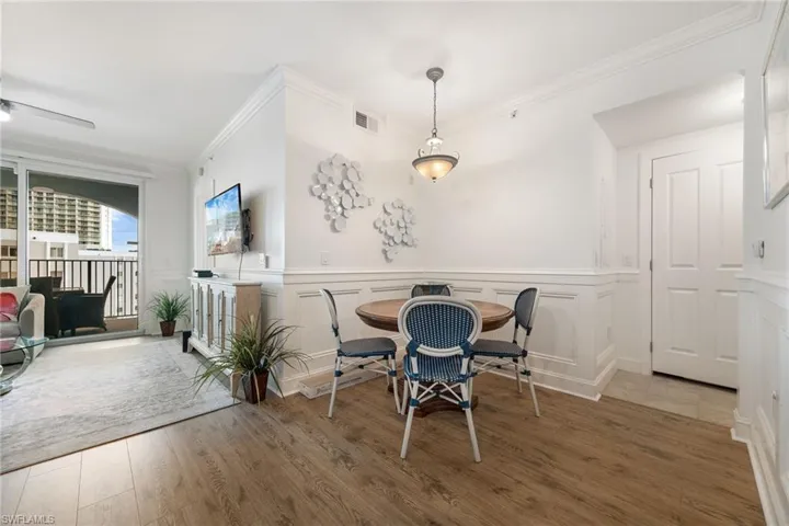 Dining room featuring hardwood / wood-style flooring and ornamental molding