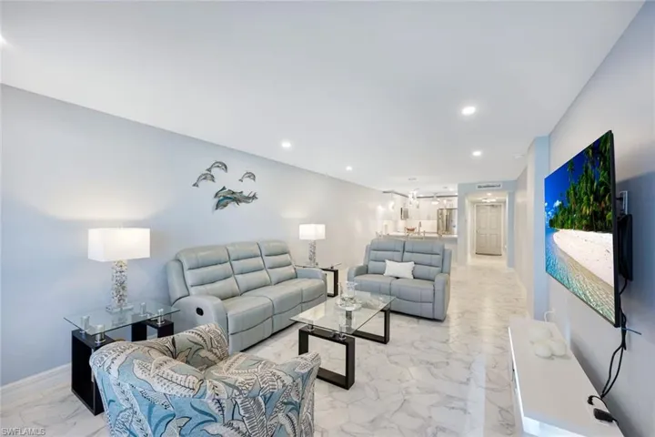 Living room featuring light marble finish floors and recessed lighting