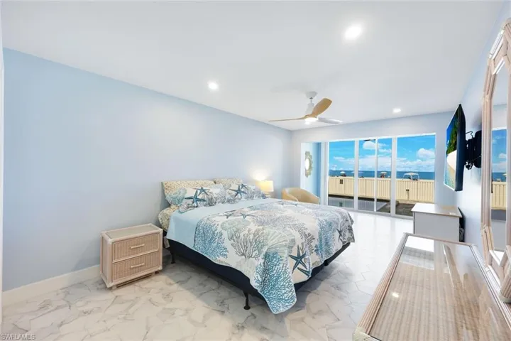 Bedroom with access to outside, recessed lighting, light marble finish flooring, and ceiling fan