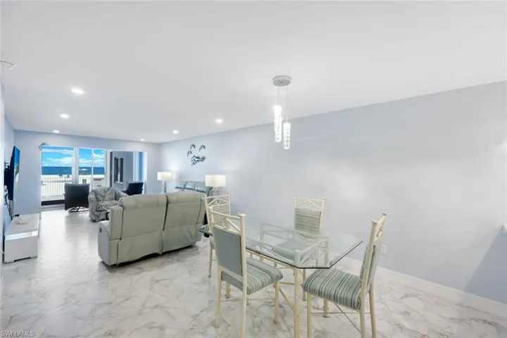 Dining area featuring recessed lighting and marble finish flooring