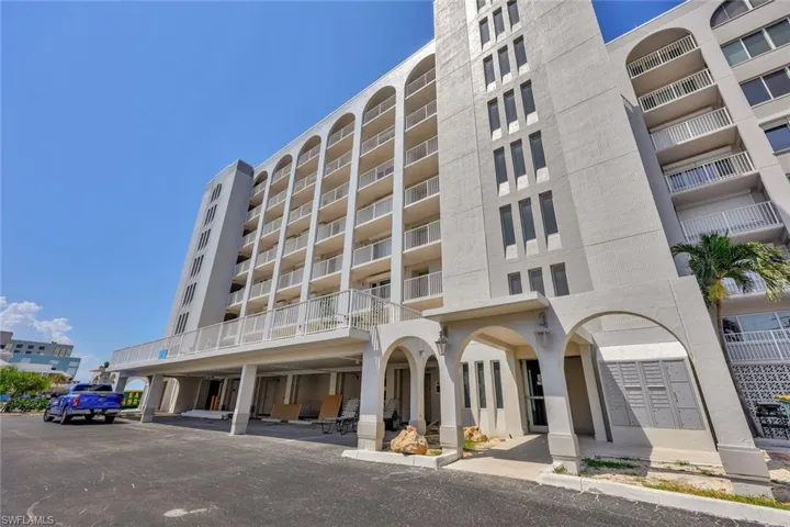 View of apartment building / complex featuring a parking lot