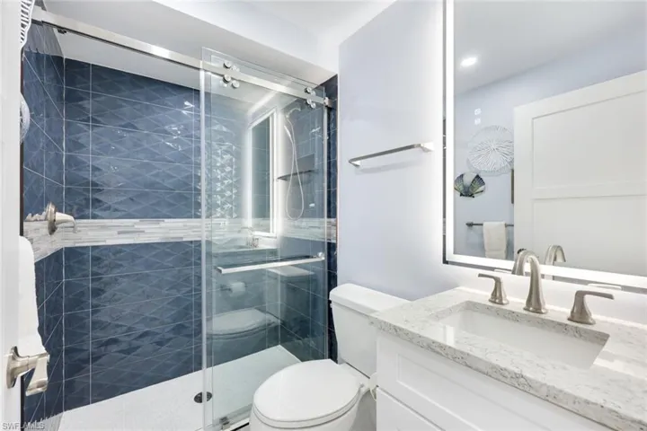 Full bath featuring vanity and a shower stall