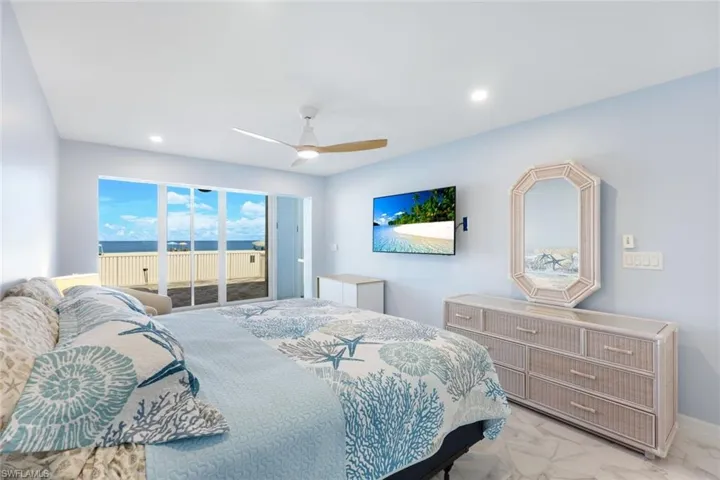 Bedroom featuring access to outside, light marble finish floors, ceiling fan, and recessed lighting