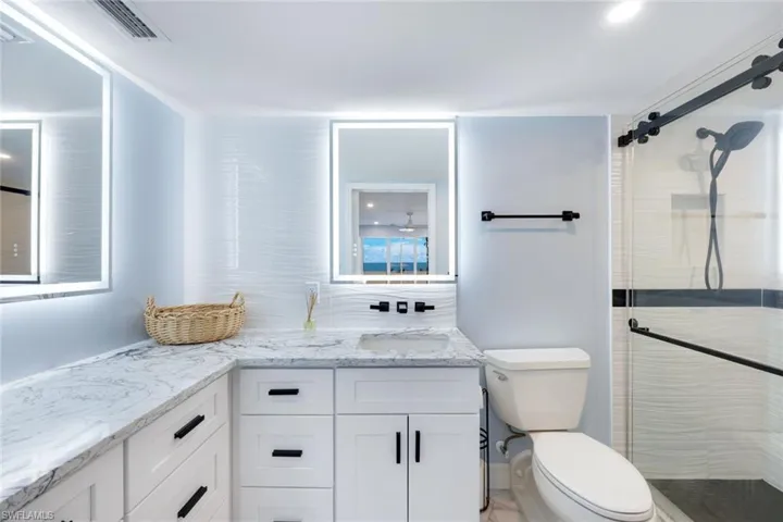 Full bath with vanity and a stall shower