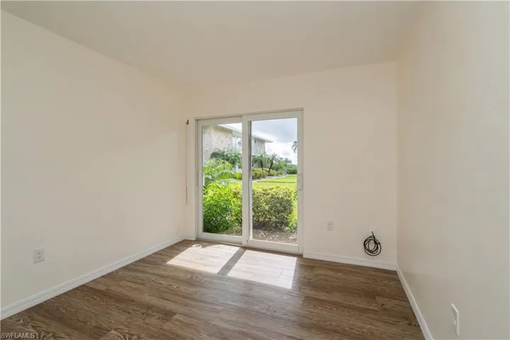 Empty room featuring dark hardwood / wood-style floors