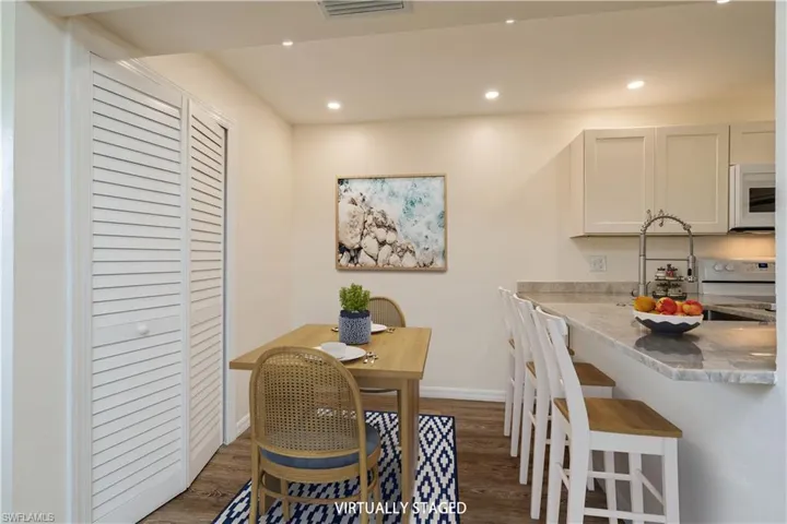Dining space with dark hardwood / wood-style flooring and sink