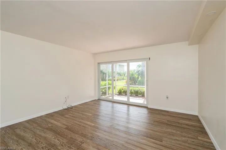 Empty room with dark wood-type flooring