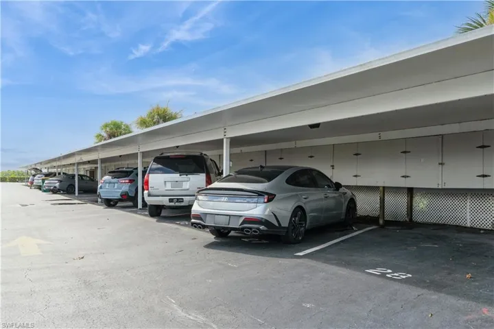 View of parking featuring a carport