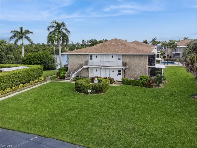 Rear view of property featuring a yard