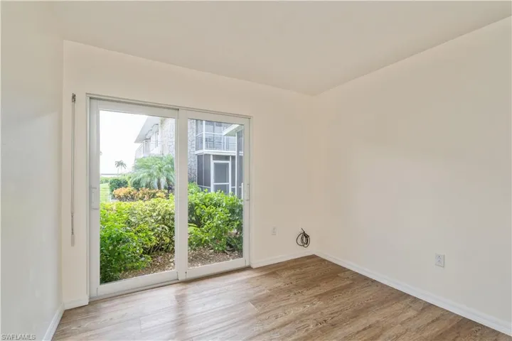 Unfurnished room with a wealth of natural light and light hardwood / wood-style floors