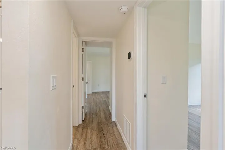 Corridor with light hardwood / wood-style flooring