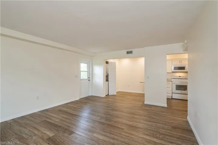 Spare room featuring wood-type flooring