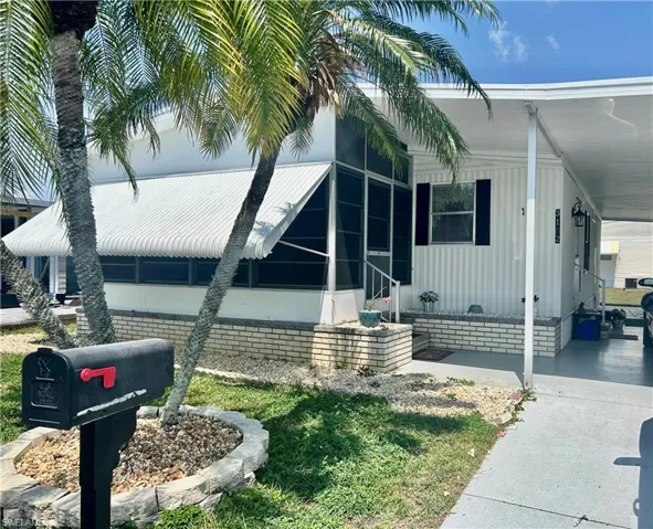 View of side of property featuring a carport