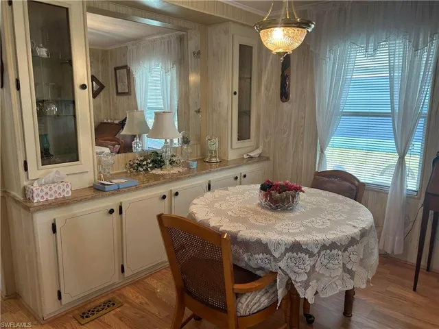Dining room with light hardwood / wood-style floors and ornamental molding