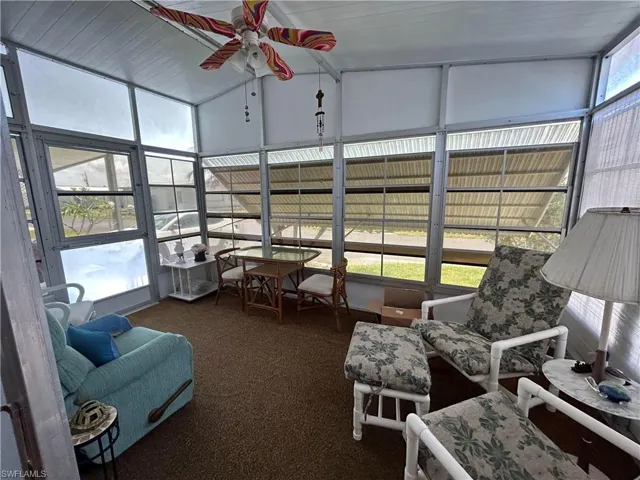Sunroom featuring a wealth of natural light, ceiling fan, and lofted ceiling