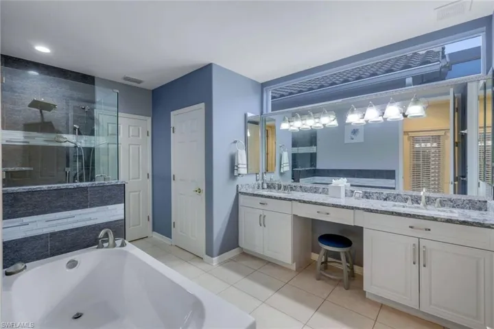 Updated master Bathroom featuring walk in shower, vanity, soaker tub.
