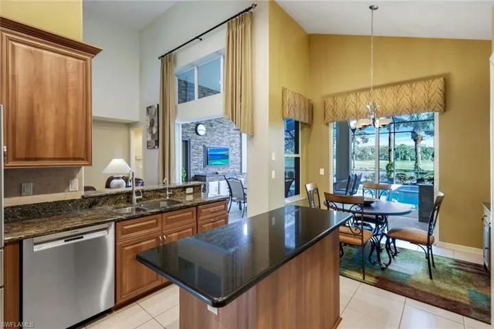 Updated Island Kitchen featuring stone countertops, stainless steel appliances, overlooking pool, water and golf course.