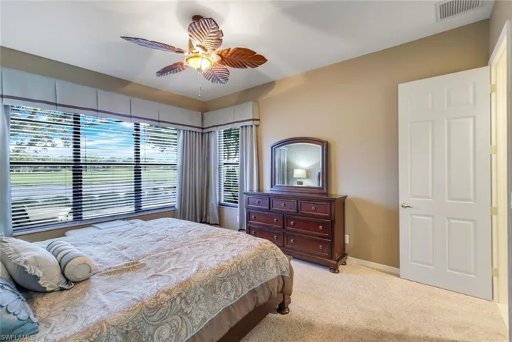 Furnished Master Bedroom with pool, golf and water view