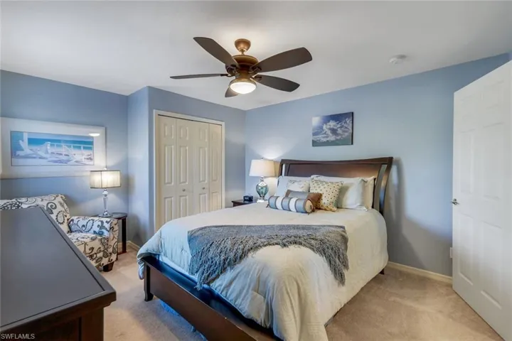 Bedroom #3 with private ensuite bath, a closet and ceiling fan/light.