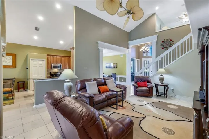 Grand room featuring fan-a-mation fan, high vaulted ceiling. Home sold furnished with couple exclusions.