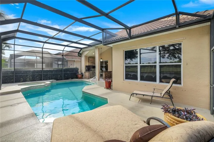 View of pool featuring an in ground hot tub, a lanai, and a patio