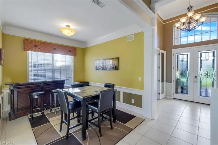 Formal Dining area, ornamental molding, spacious entry foyer with Distinctive Custom French Entry doors.
