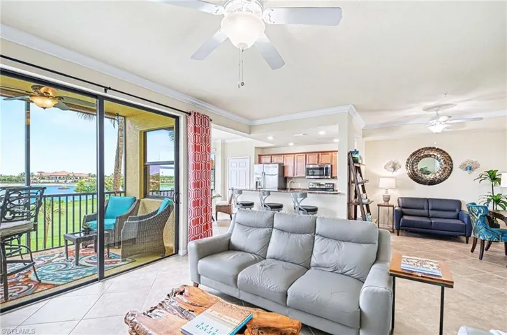 Living area featuring tile flooring, crown molding, and a ceiling fan