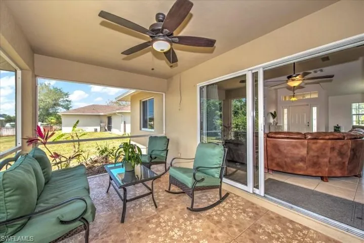 Sunroom / solarium featuring ceiling fan