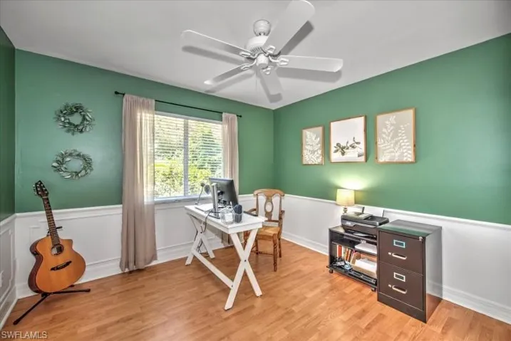 Office with ceiling fan and light hardwood / wood-style flooring