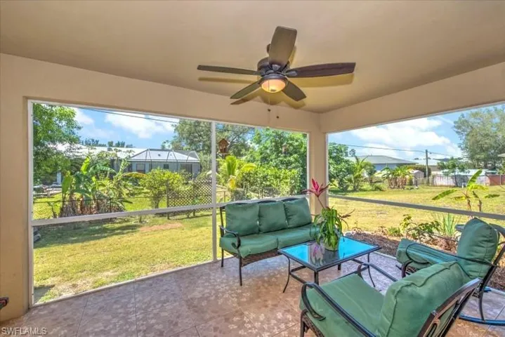 Sunroom / solarium featuring ceiling fan