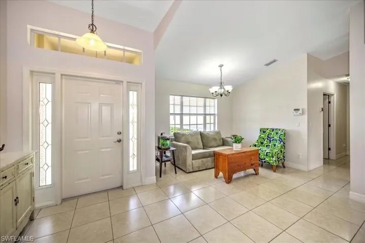 Foyer featuring a notable chandelier and light tile floors