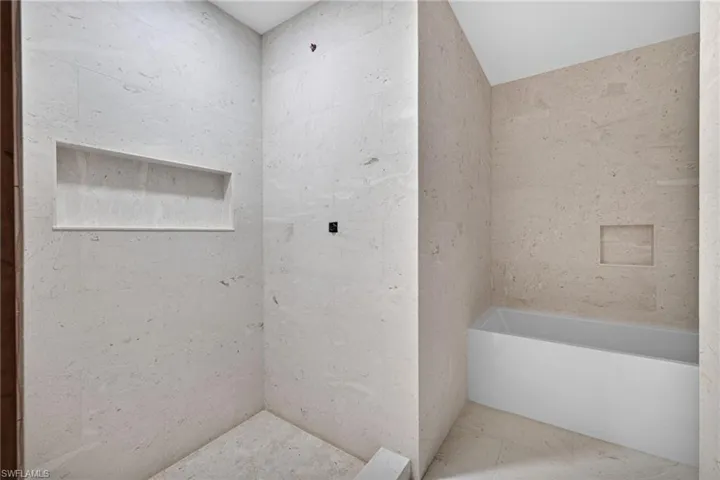 Beautiful Travertine tile shower and separate tub