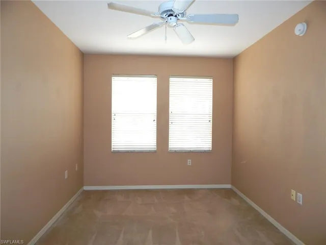 Unfurnished room with ceiling fan and light colored carpet