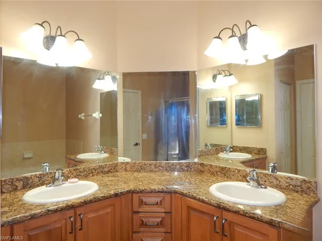 Bathroom featuring vanity and a chandelier