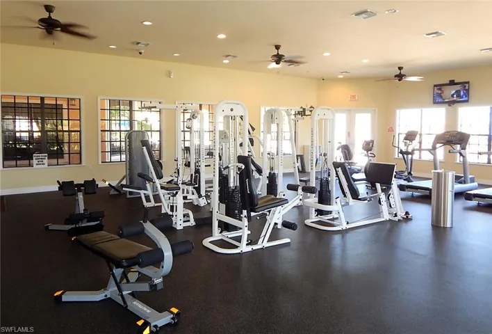 Exercise room featuring a wealth of natural light and ceiling fan