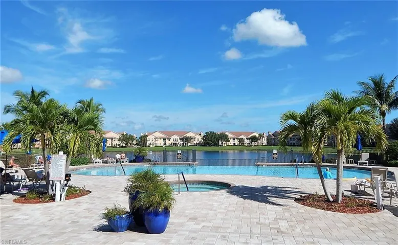 View of swimming pool with a patio and a water view