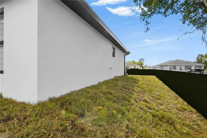 View of side of home with stucco siding