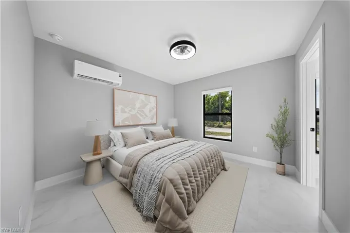 Bedroom with baseboards and a wall mounted AC