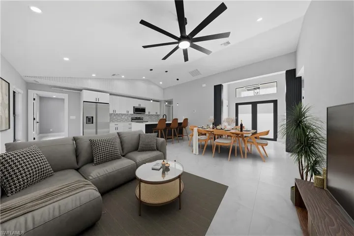 Living room featuring ceiling fan, recessed lighting, and vaulted ceiling