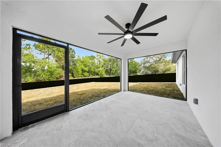 Unfurnished sunroom featuring a ceiling fan