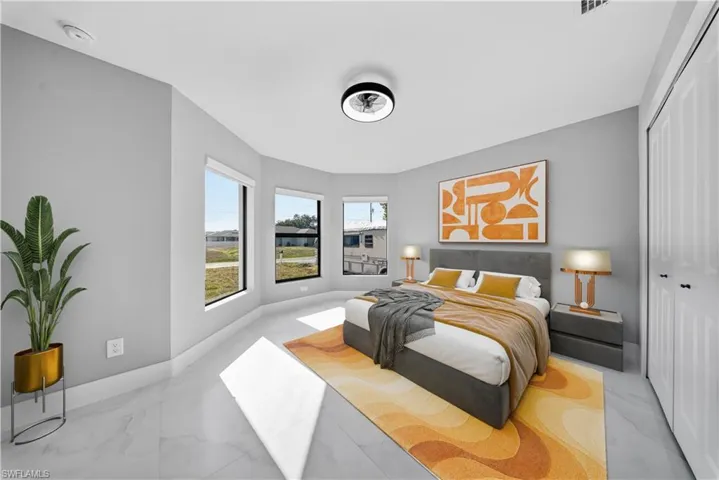 GUEST Bedroom #1 featuring light marble finish flooring and a closet
