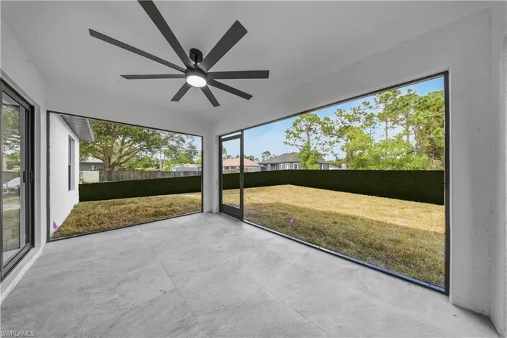 Unfurnished sunroom with ceiling fan and healthy amount of natural light