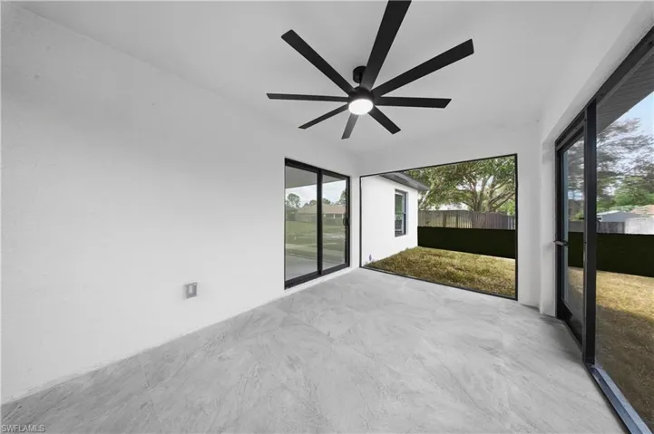 Unfurnished sunroom with a ceiling fan