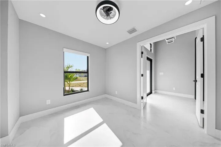 Spare room featuring light marble finish floors and recessed lighting