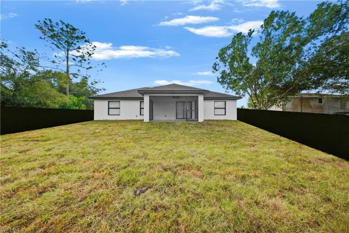 Rear view of property featuring a fenced backyard, stucco siding, and a patio