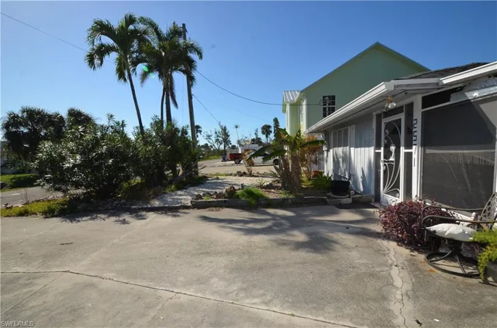 Front lawn and extra large concrete driveway.