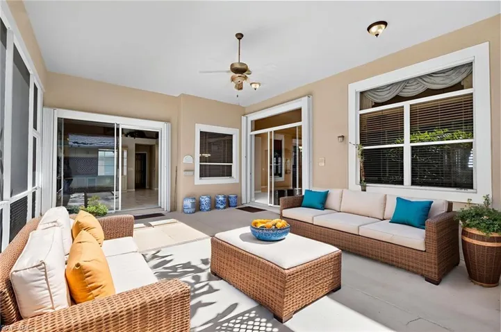 Sunroom with outdoor lounge area, a ceiling fan, and a patio area