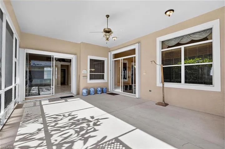 View of patio featuring ceiling fan and a sunroom