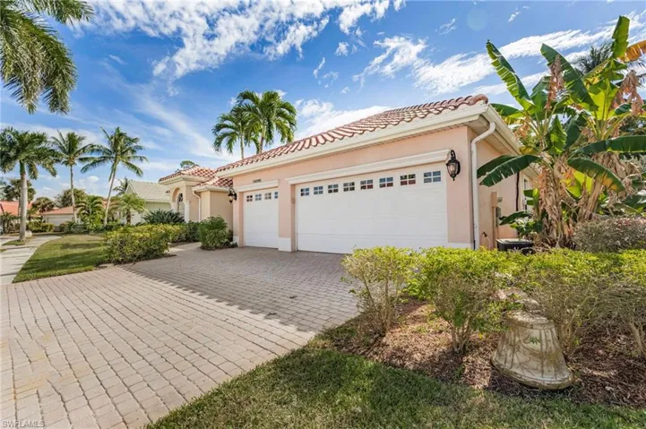 Mediterranean / spanish home featuring stucco siding, a garage, decorative driveway, and a tile roof