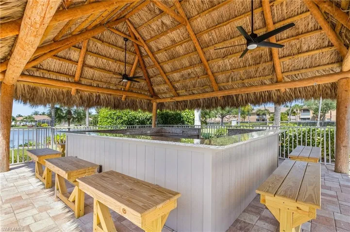 View of patio / terrace with ceiling fan and a water view